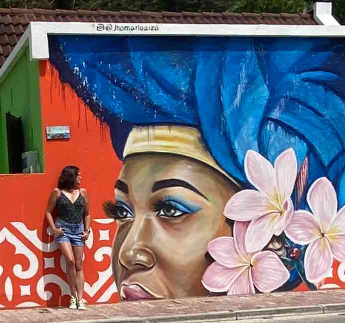 painel de street art representando mulher negra com flores no cabelo