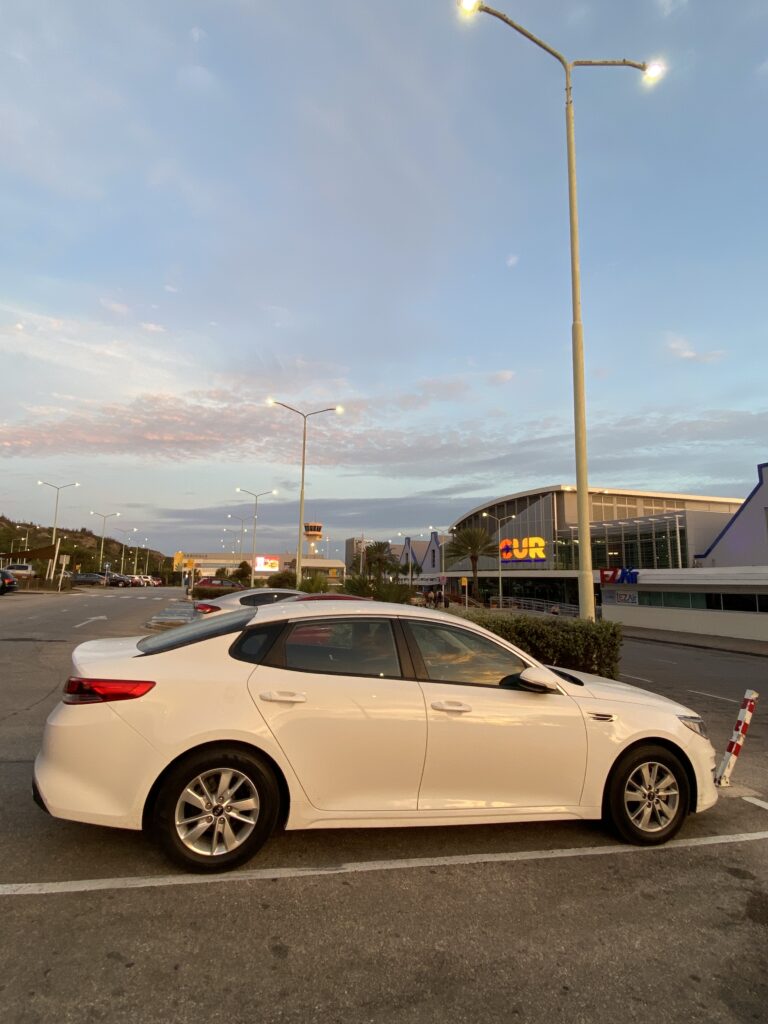 carro branco parado no estacionamento do aeroporto